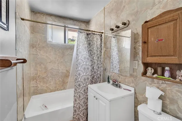 a bathroom with a sink mirror toilet and bathtub