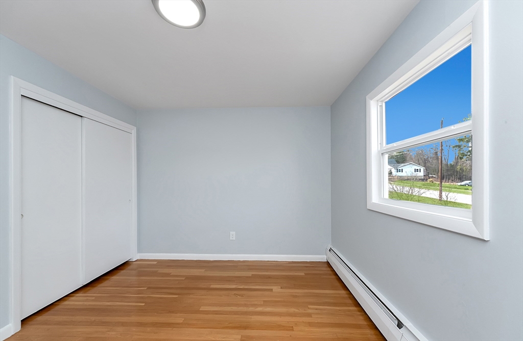 164 Sterling Road Lancaster, MA 01523 - Photo 18 of 36 a view of an empty room with wooden floor and a window