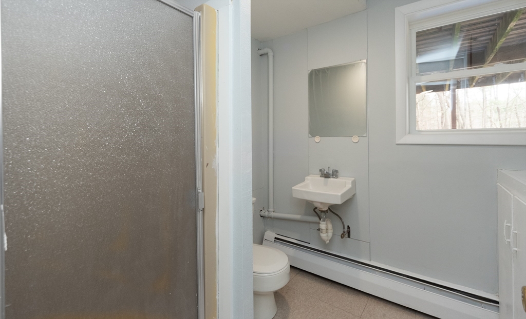 164 Sterling Road Lancaster, MA 01523 - Photo 30 of 36 a bathroom with a toilet a sink and mirror