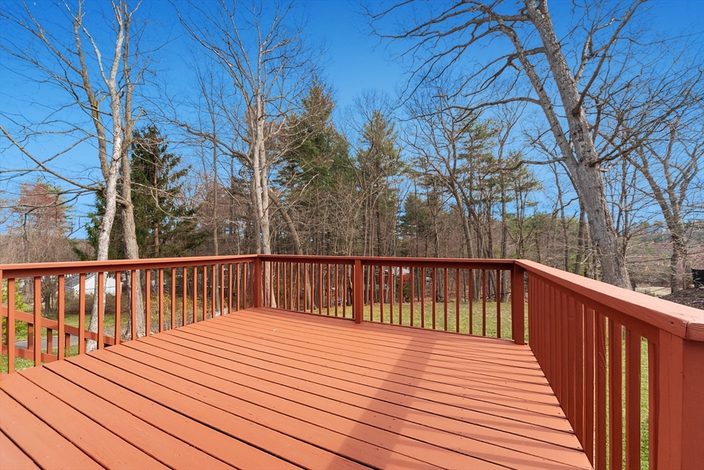 164 Sterling Road Lancaster, MA 01523 - Photo 3 of 36 a balcony with wooden floor and trees