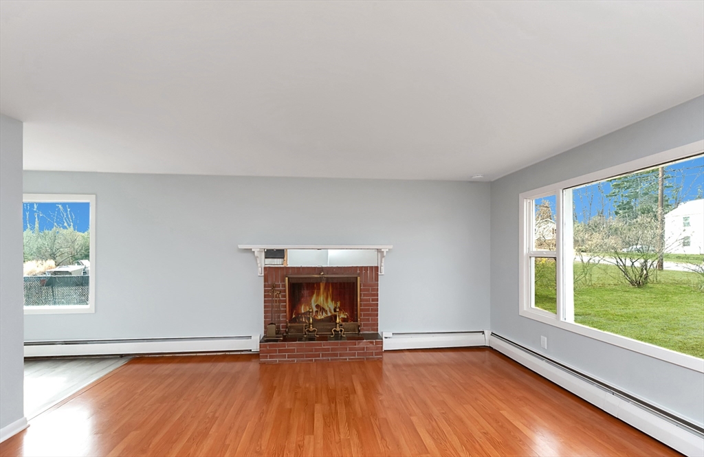 164 Sterling Road Lancaster, MA 01523 - Photo 9 of 36 a view of an empty room with wooden floor and a window