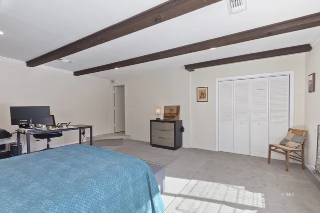 a bedroom with furniture and a window