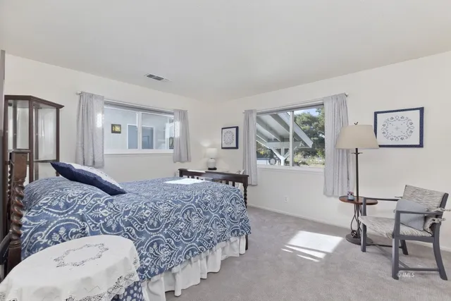 a bedroom with a large bed and a dresser