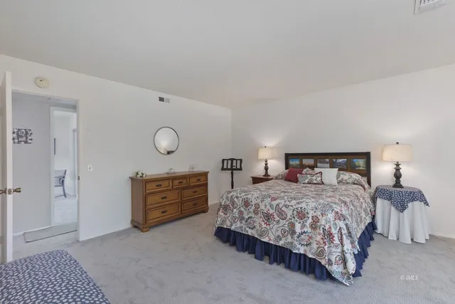 a bedroom with a bed and cabinets