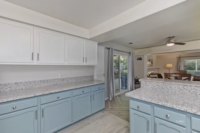 a kitchen with granite countertop a sink and cabinets