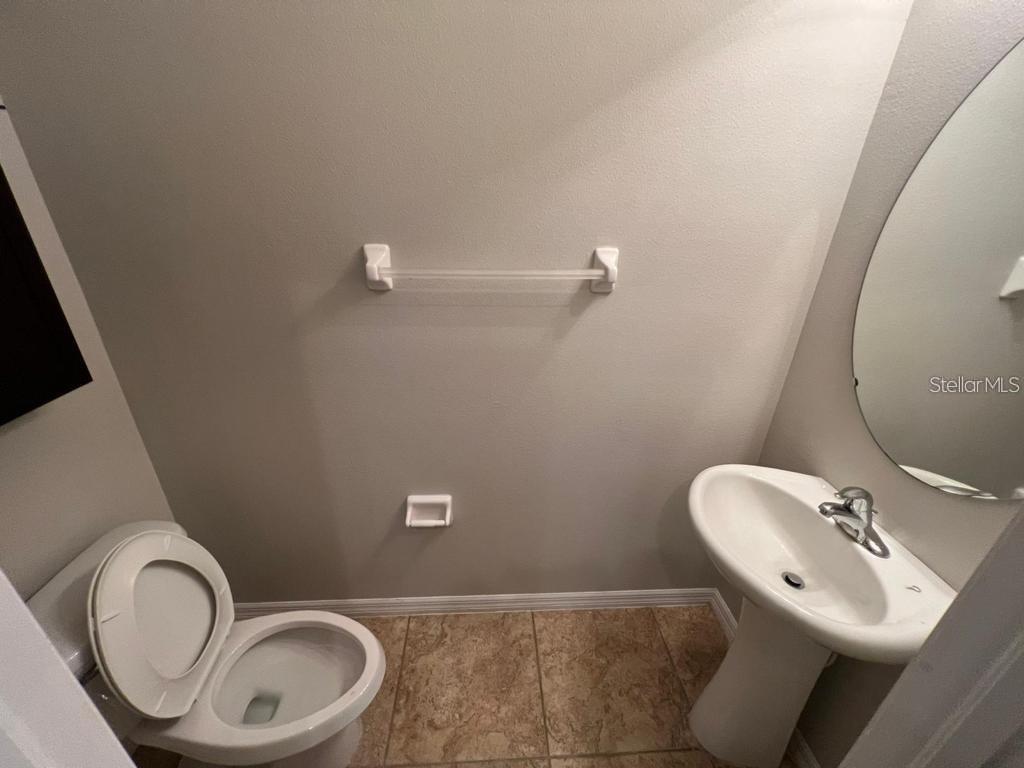 8301 Pine River Road Tampa, FL 33637 - Photo 12 of 16 a bathroom with a toilet sink and mirror