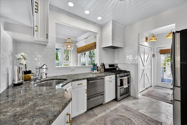 a bedroom with a bed wooden floor and view living room