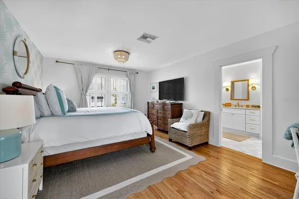 a front view of a house with a yard and potted plants