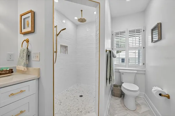 a kitchen with a refrigerator a stove a sink and white cabinets with wooden floor