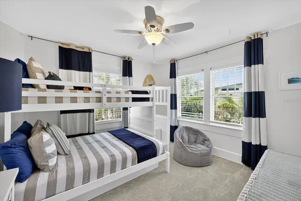 a view of living room with furniture and large windows