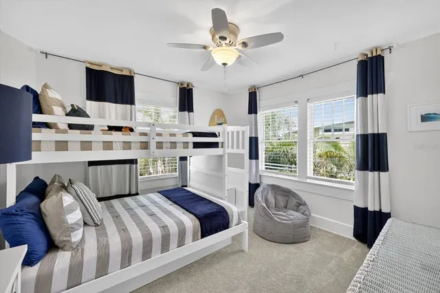 a front view of a house with a yard and potted plants