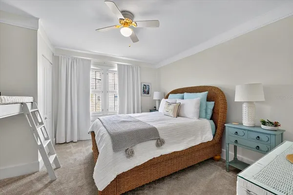 a living room with furniture floor to ceiling window and wooden floor