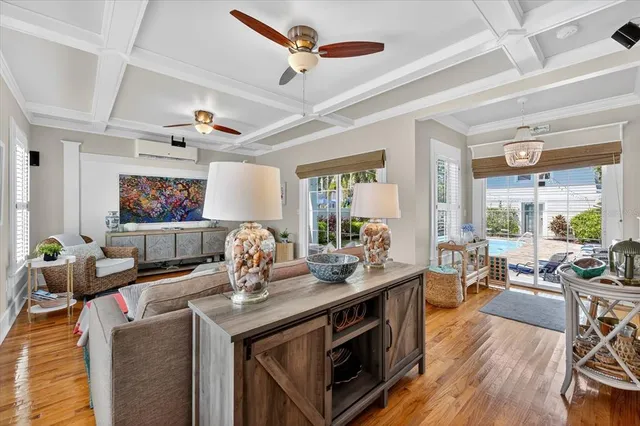 a living room with furniture a rug and a large window