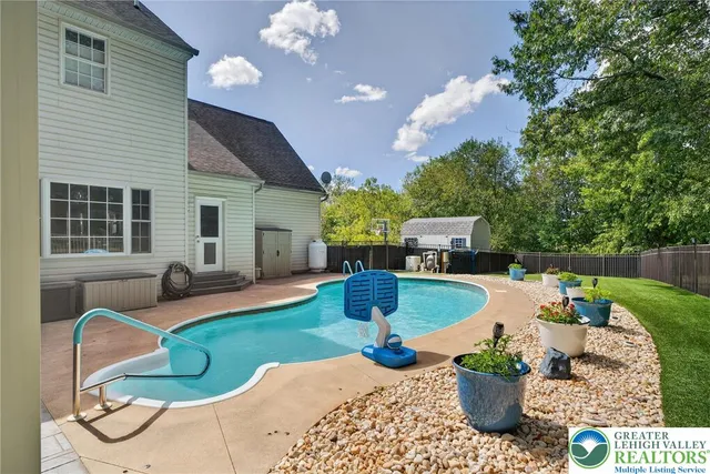 a kitchen with granite countertop a sink white cabinets and stainless steel appliances