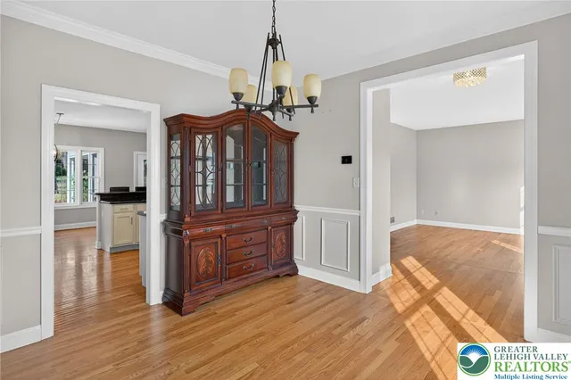 a view of a room with wooden floor and a ceiling fan