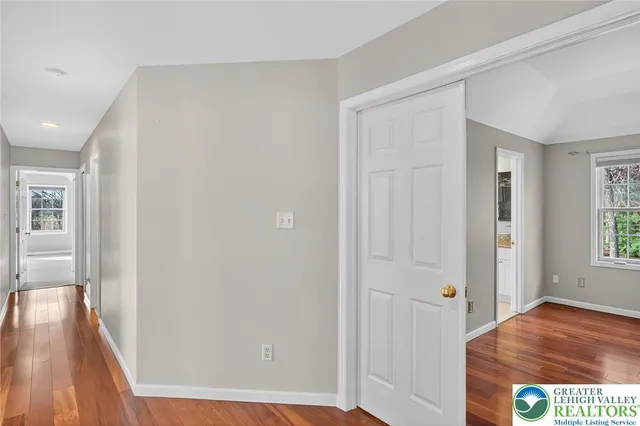 a bathroom with a toilet and a glass door shower