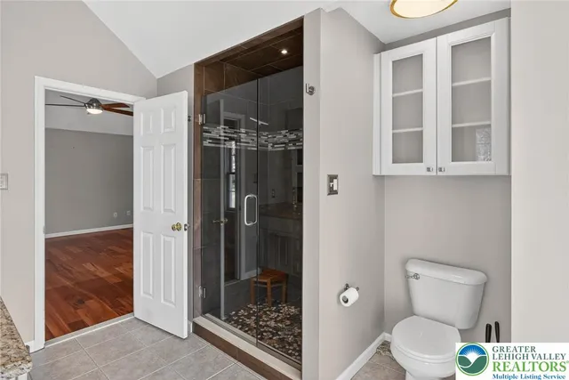 a bathroom with a sink a toilet and shower curtain