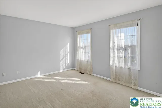 a view of a deck with a bench and floor to ceiling window