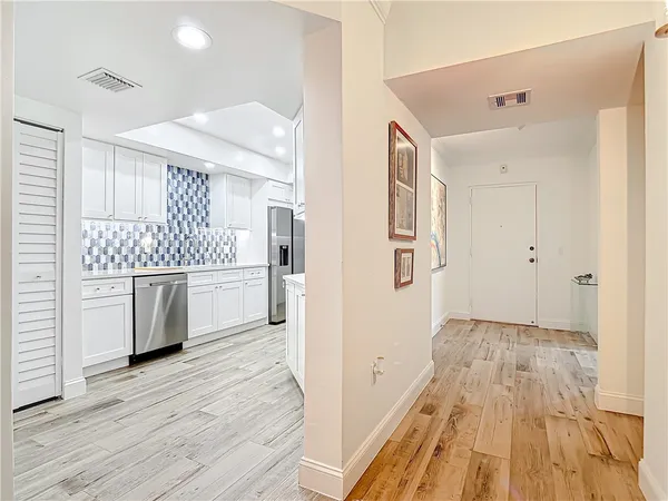 a kitchen with a sink and wooden floor