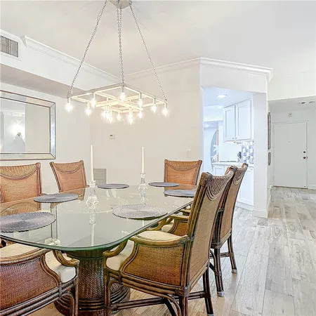 a view of a dining room with furniture and chandelier