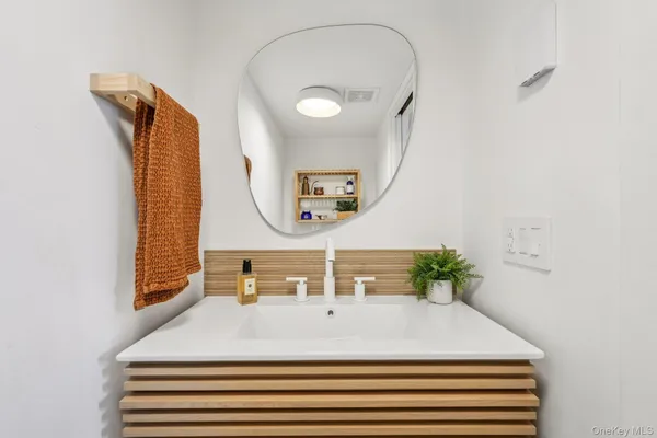 a bedroom with a bed and a mirror