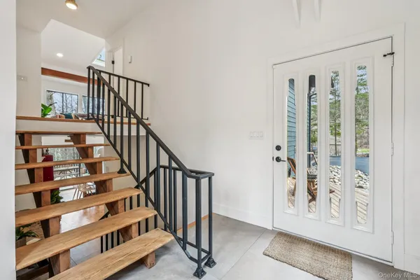 a view of a hallway with wooden floor and entryway