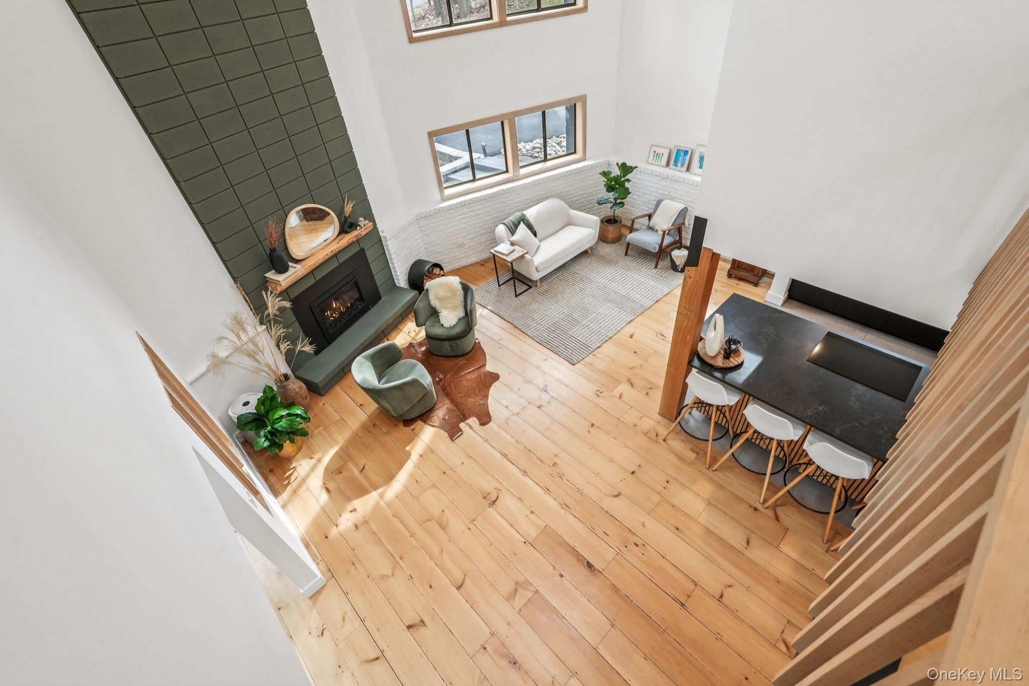 4 Mountain Brook Road Cornwall, NY 12518 - Photo 24 of 45 Living room with wood-type flooring, a high ceiling, and a lit fireplace