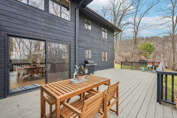 a view of a patio with table and chairs and wooden floor