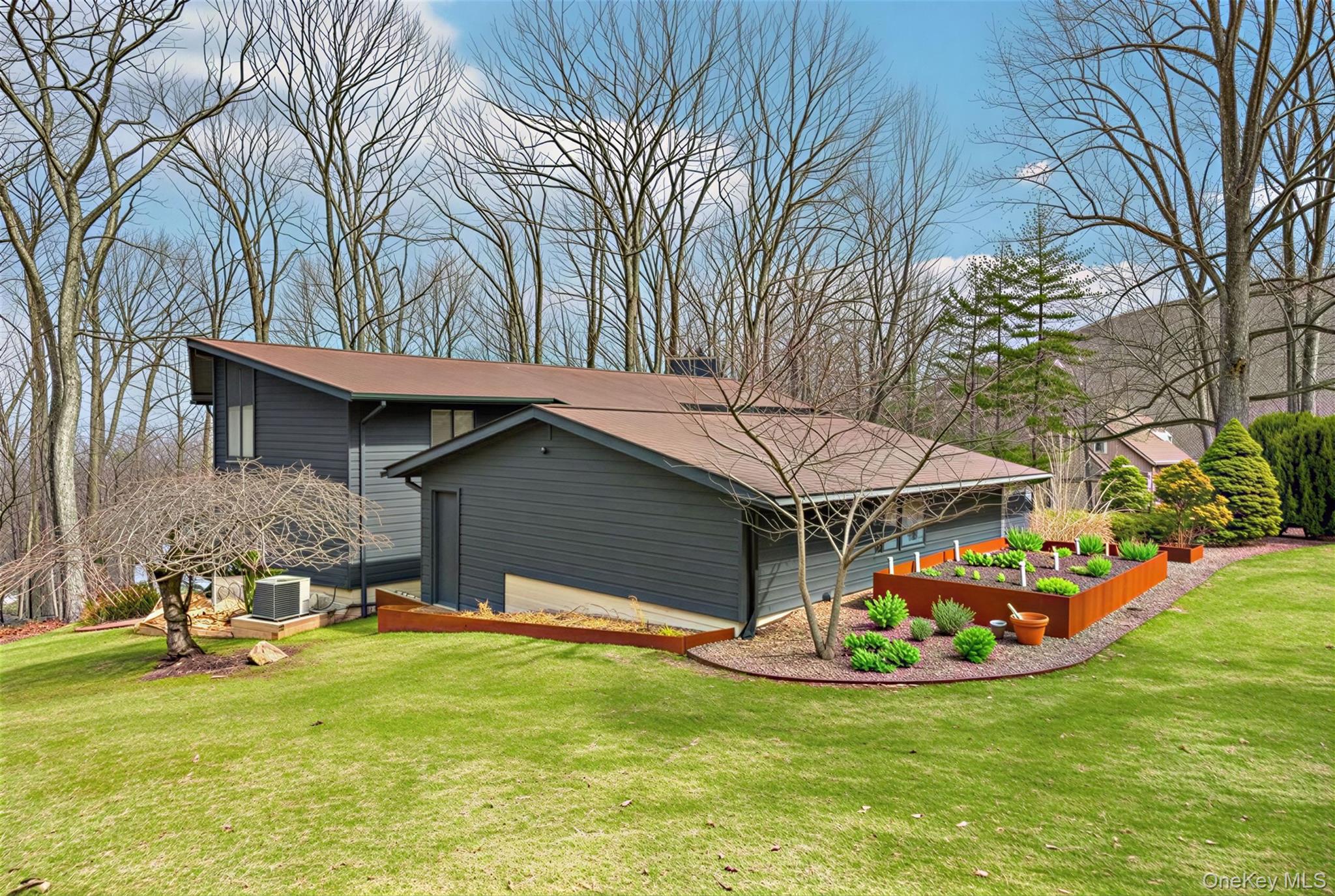 4 Mountain Brook Road Cornwall, NY 12518 - Photo 32 of 45 View of side of home featuring a garden and a lawn virtually staged garden