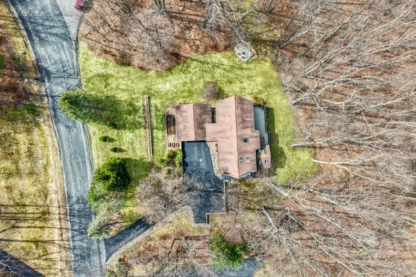 a pathway of a house with a yard