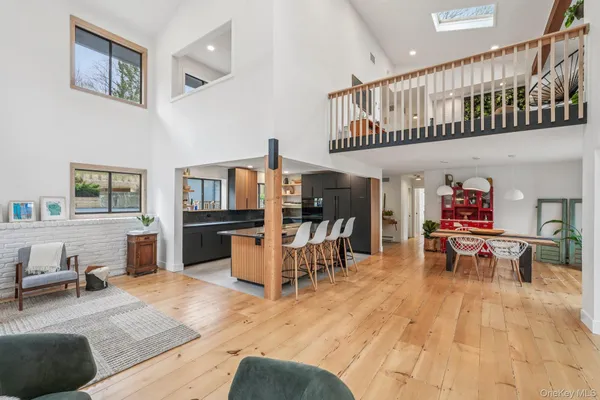 a living room with furniture and a dining table
