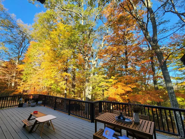 a view of balcony with wooden floor and outdoor seating