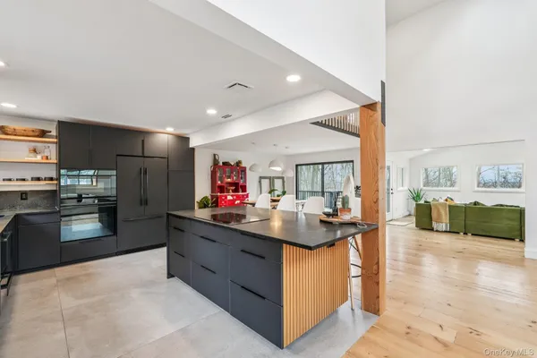 a kitchen with stainless steel appliances kitchen island granite countertop a sink and cabinets