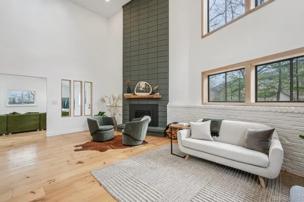 a living room with furniture a fireplace and a table