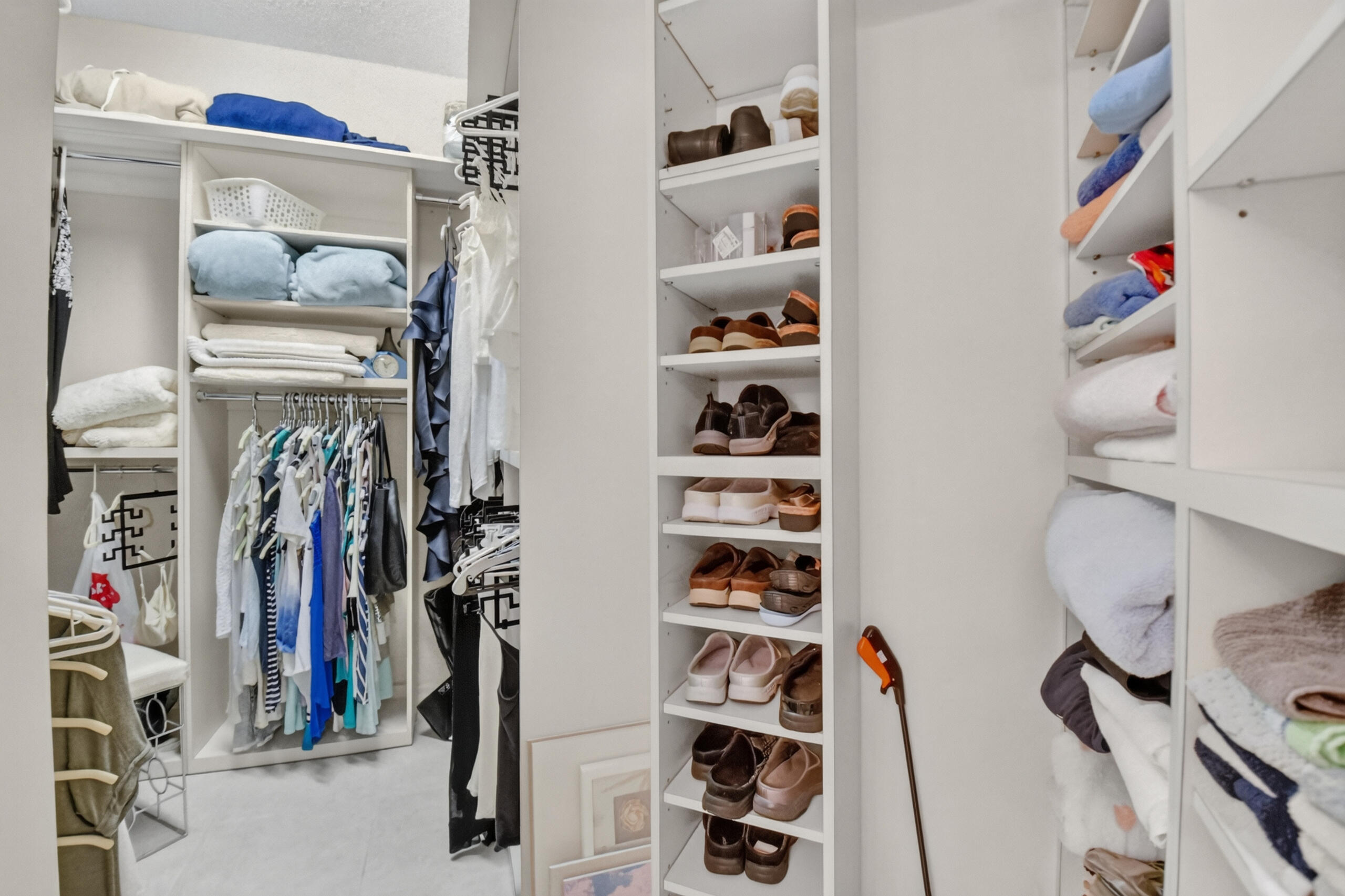 15340 Floral Club Road Delray Beach, FL 33484 - Photo 27 of 42 a view of walk in closet with clothes and shoes