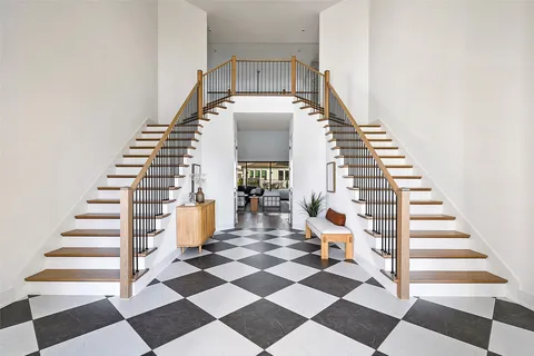 a view of entryway and hall with wooden floor