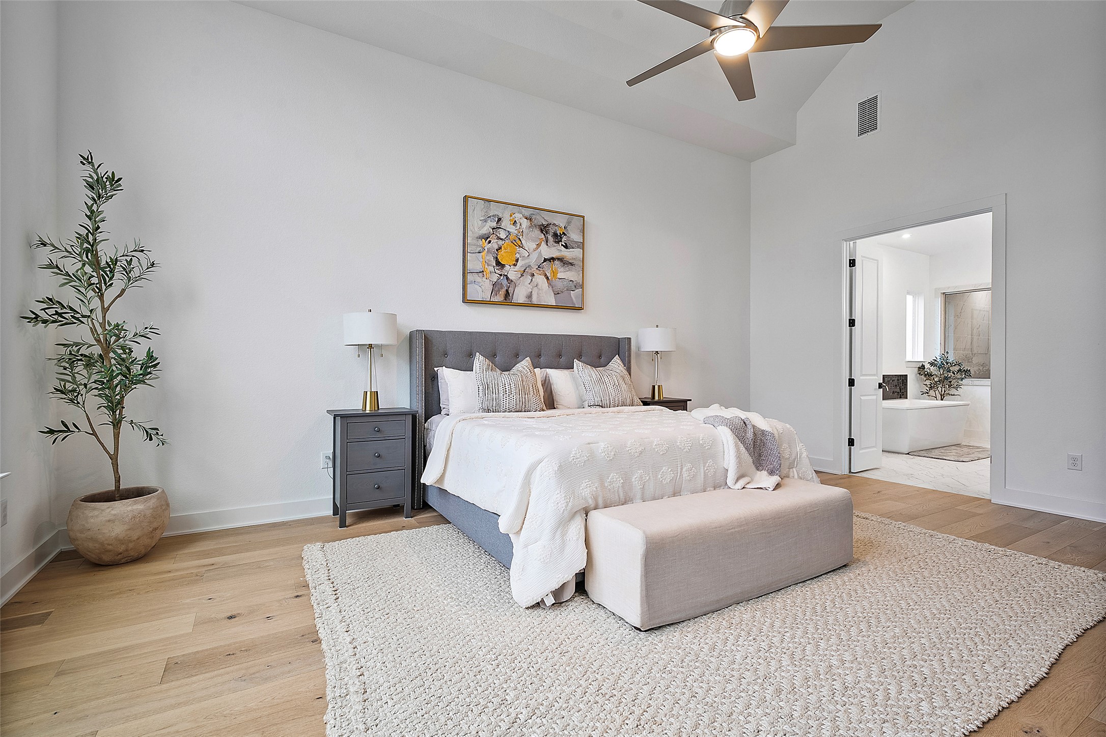 5009 Forenza Trace Leander, TX 78641 - Photo 17 of 39 a bedroom with a large bed and a potted plant