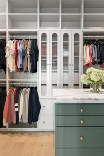 a view of walk in closet with clothes and shoes
