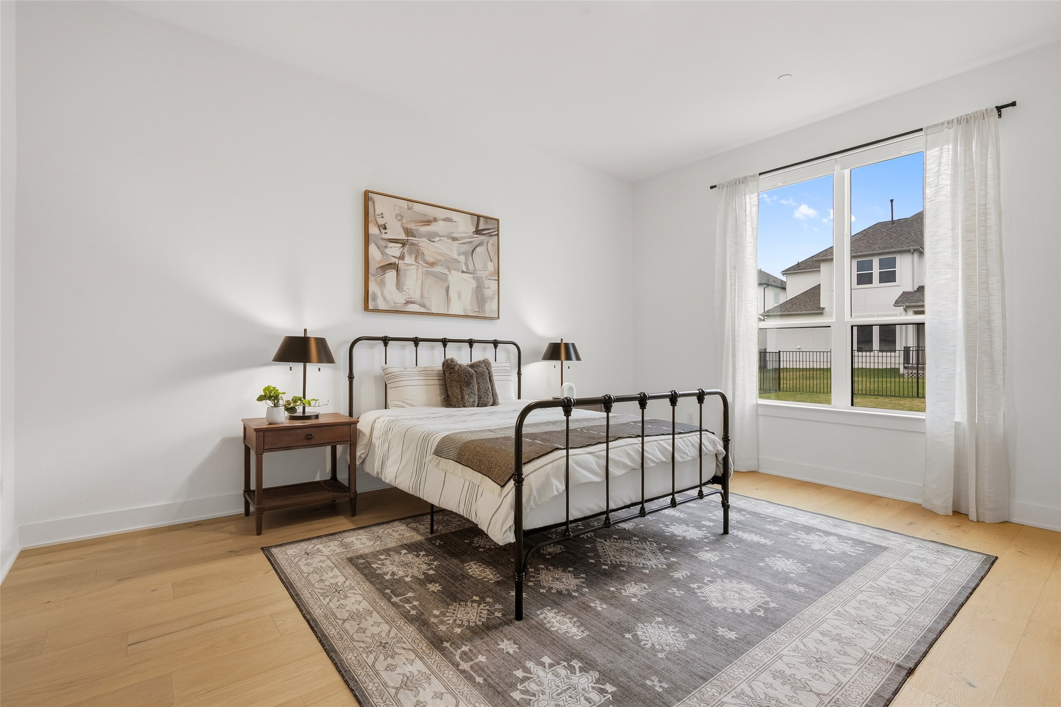 5009 Forenza Trace Leander, TX 78641 - Photo 26 of 39 a white bed sitting in a bedroom next to a window with a rug