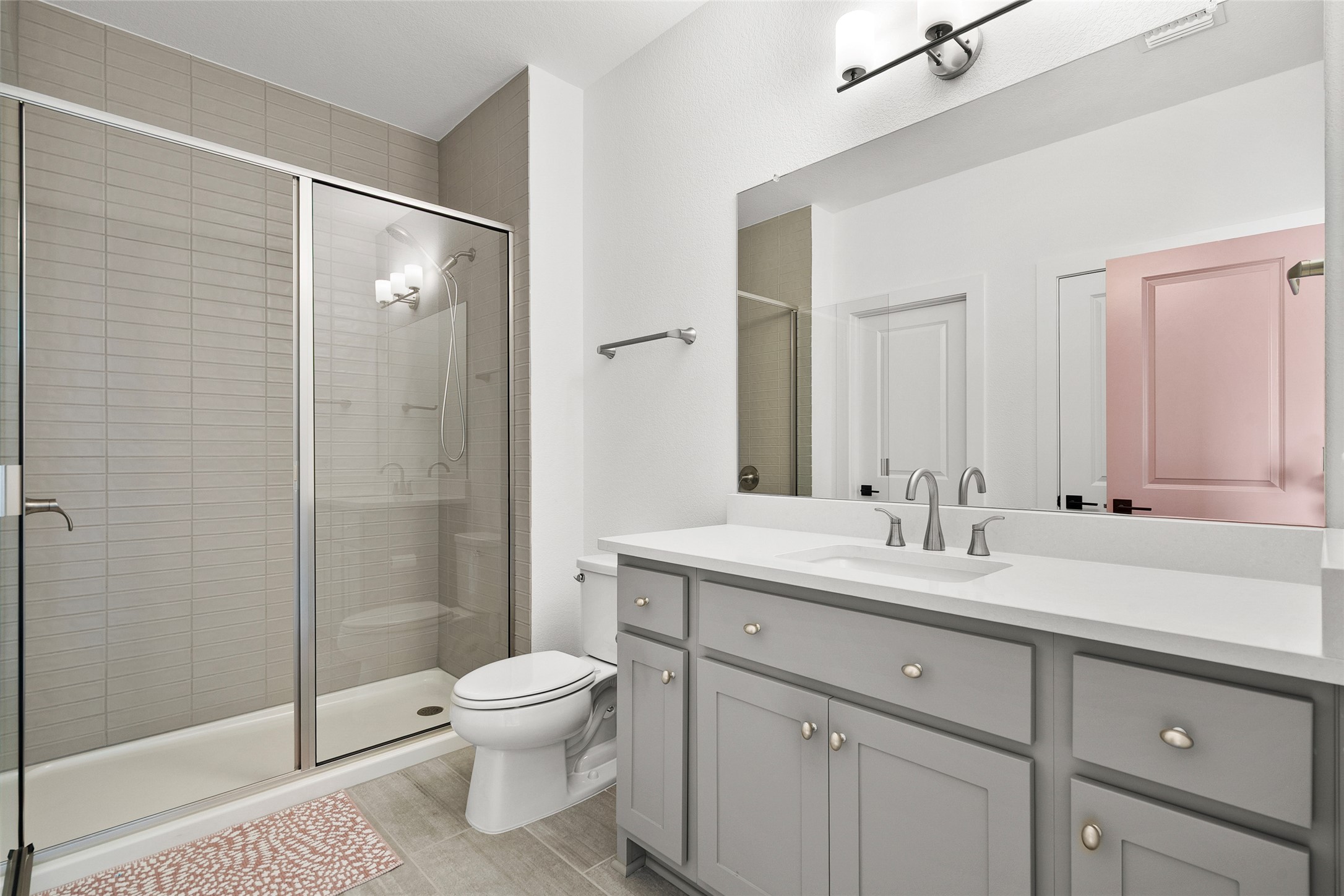 5009 Forenza Trace Leander, TX 78641 - Photo 30 of 39 a bathroom with a double vanity sink toilet mirror and shower