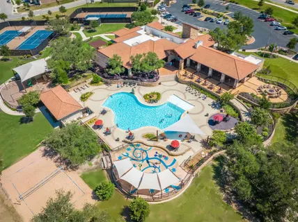 an aerial view of residential house with outdoor space and pool