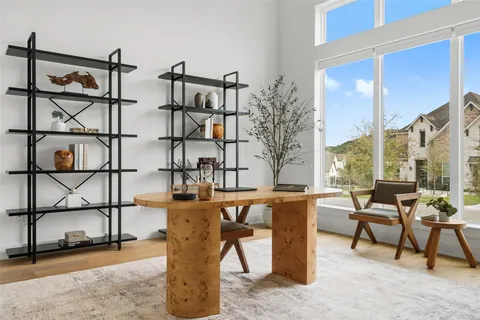 a dining room with furniture and a floor to ceiling window