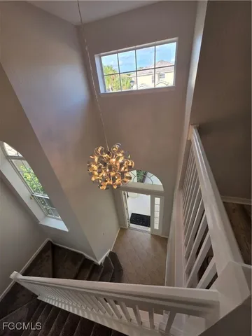 a view of a room with wooden floor and a window