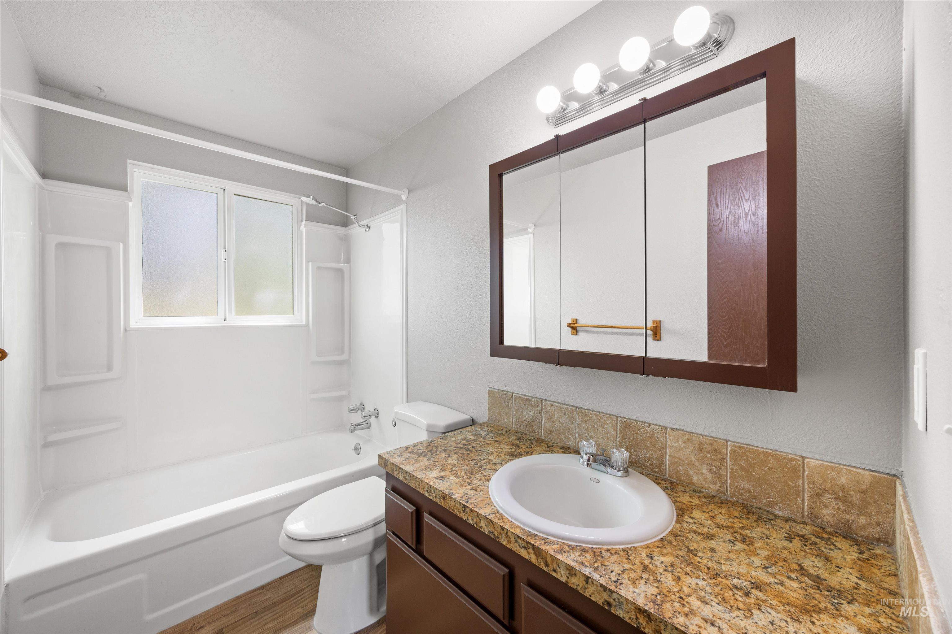 9 Villa Drive Middleton, ID 83644 - Photo 17 of 33 Full bathroom featuring a white tub and shower surround with an integrated window