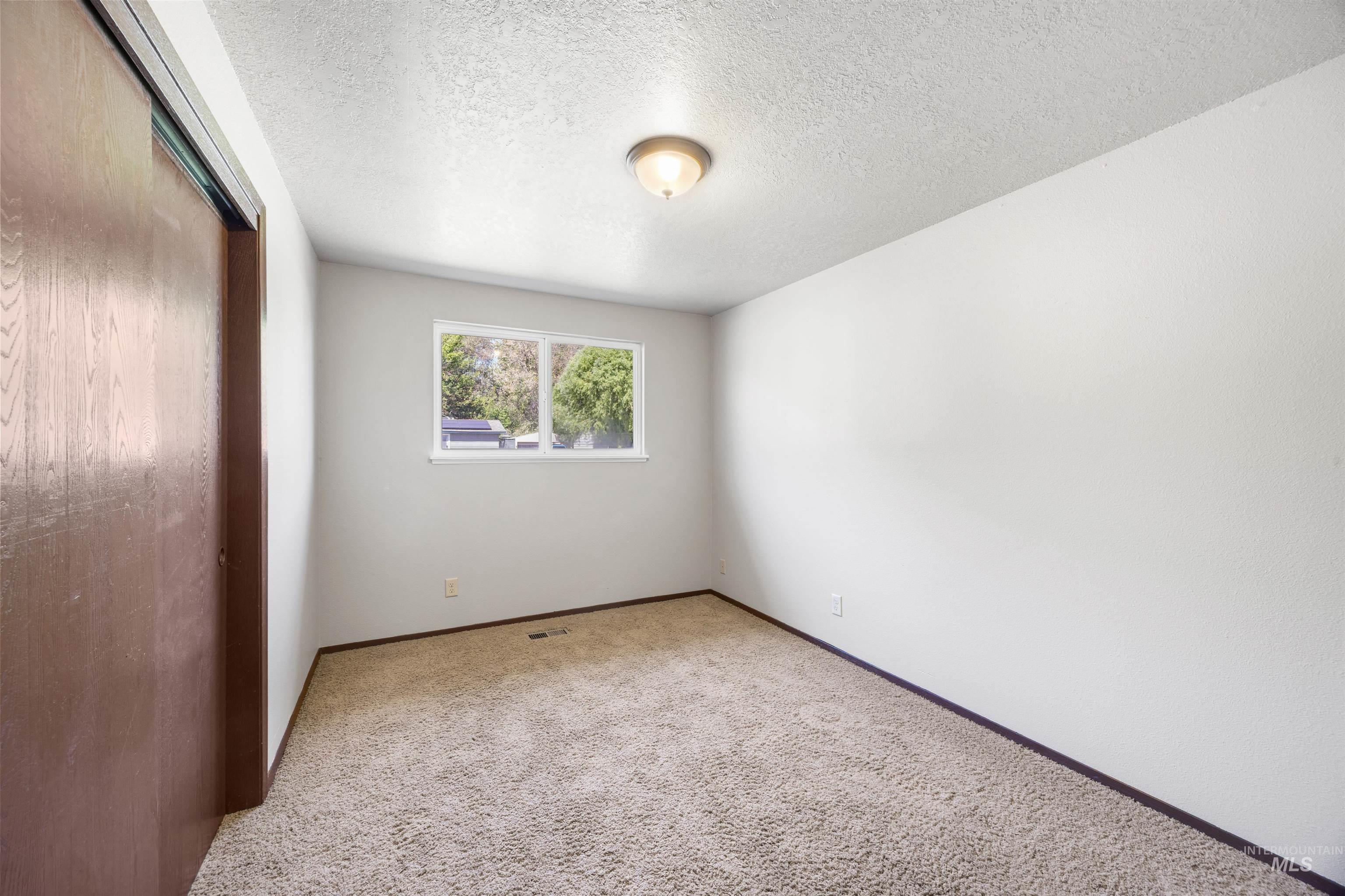 9 Villa Drive Middleton, ID 83644 - Photo 20 of 33 Carpeted bedroom with a double-pane window and a flush-mount ceiling light