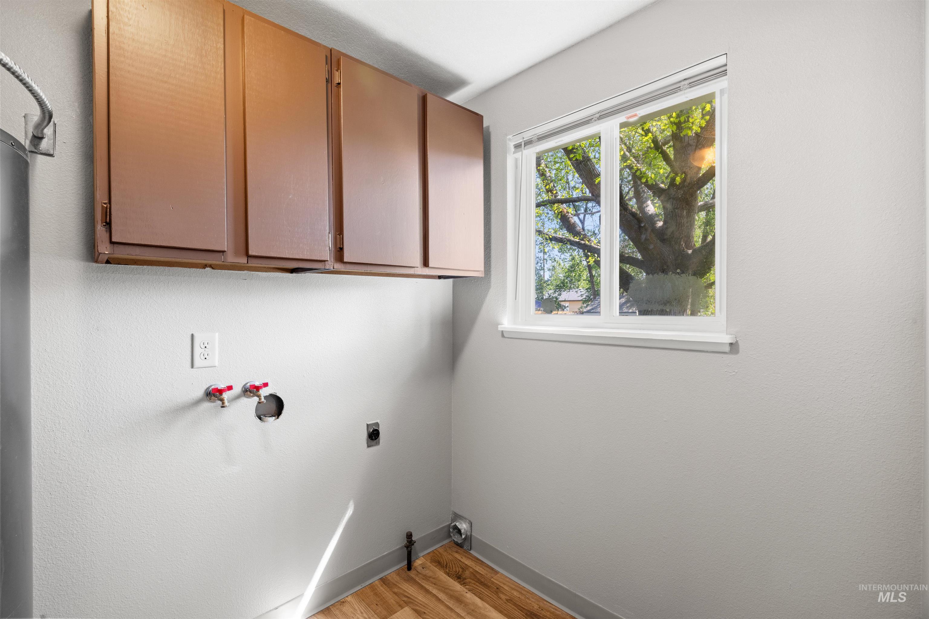 9 Villa Drive Middleton, ID 83644 - Photo 21 of 33 Dedicated utility area featuring wood-finish flooring and a white-framed window
