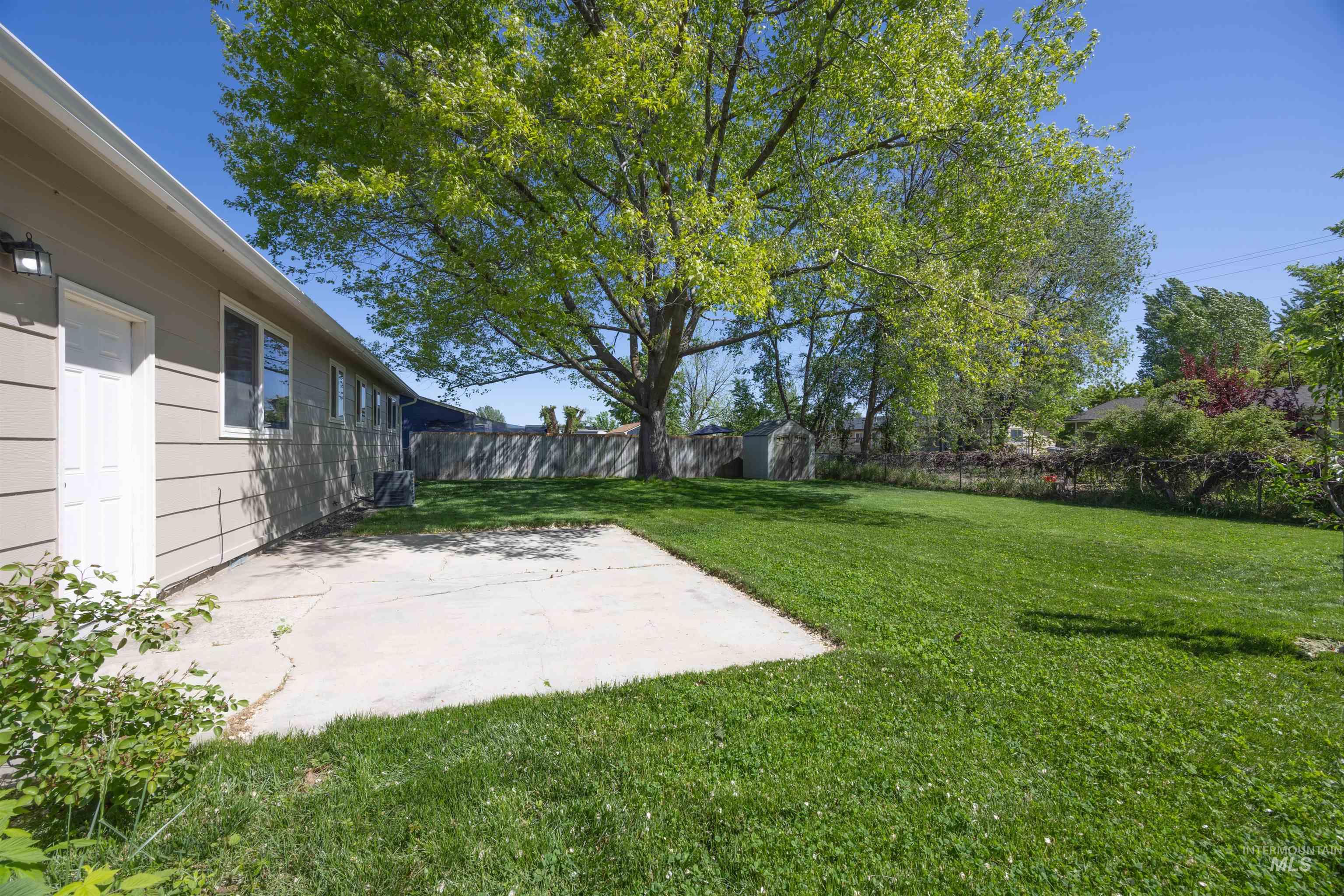 9 Villa Drive Middleton, ID 83644 - Photo 27 of 33 Expansive rear lawn featuring a large mature shade tree and a concrete patio pad