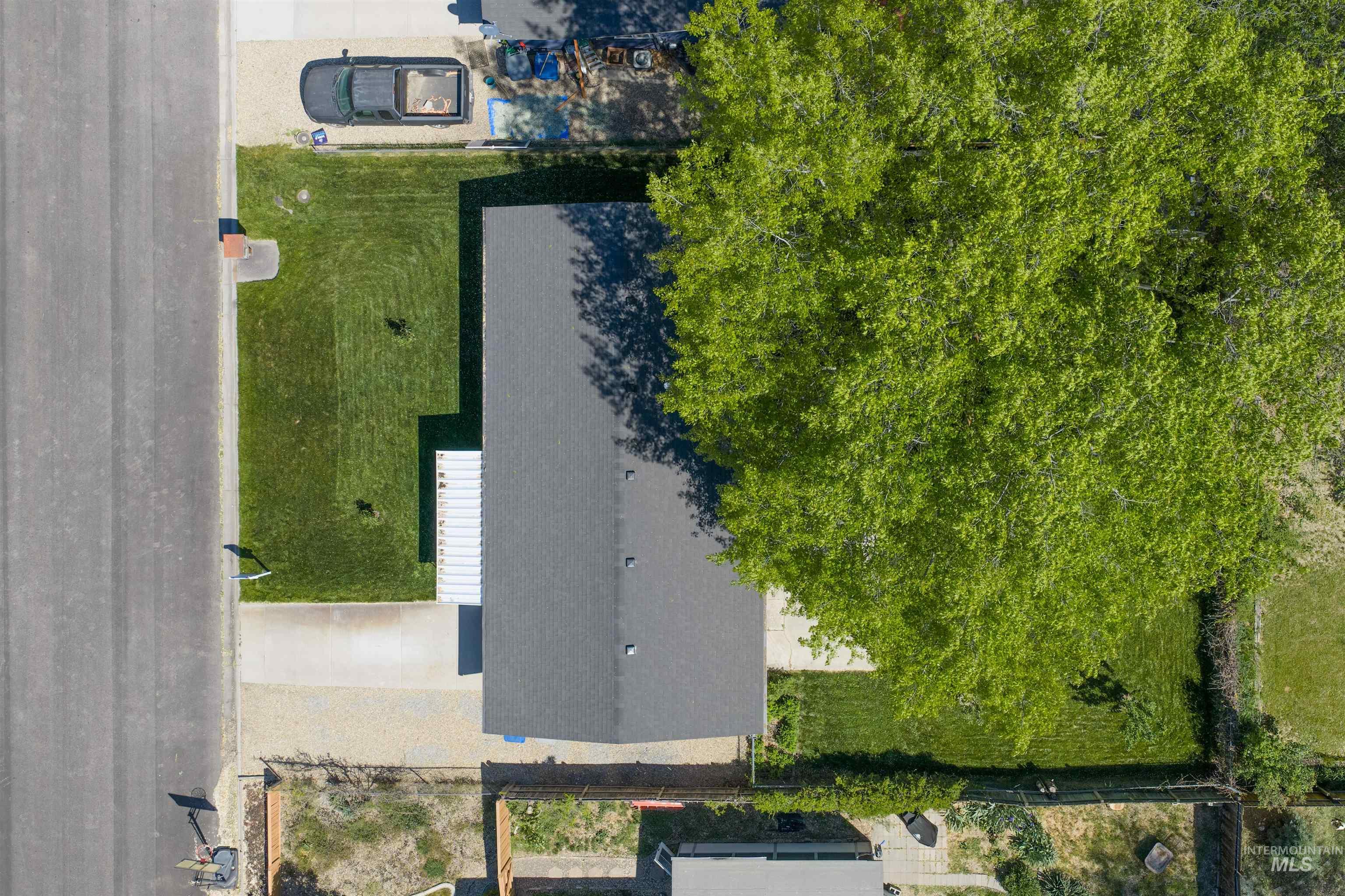 9 Villa Drive Middleton, ID 83644 - Photo 29 of 33 Single-story residence with a dark gray shingle roof, a light-colored gravel driveway, and a front lawn
