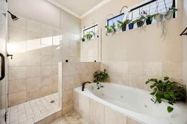 a view of a patio with table and chairs and potted plants with wooden floor and fence
