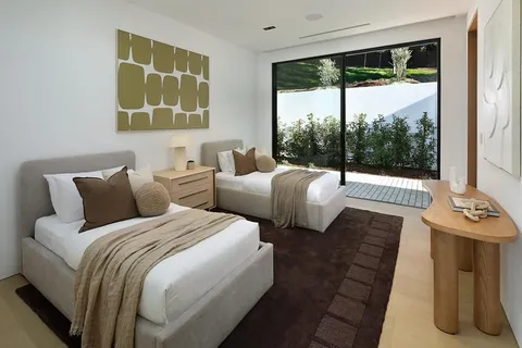 a bedroom with a bed and a painting on the wall